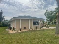 26129 Madras Ct, Punta Gorda, FL 33983 - view of side of property with a lawn