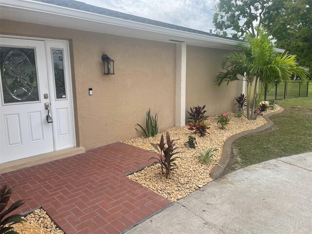 26129 Madras Ct, Punta Gorda, FL 33983 - doorway to property featuring stucco siding