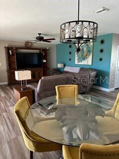26129 Madras Ct, Punta Gorda, FL 33983 - dining space with wood finished floors, baseboards, a chandelier, and a ceiling fan
