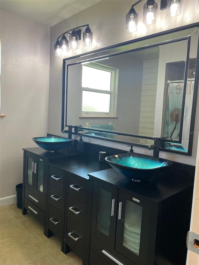 26129 Madras Ct, Punta Gorda, FL 33983 - full bathroom with double vanity, tile patterned floors, baseboards, and curtained shower