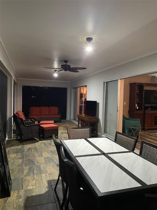 26129 Madras Ct, Punta Gorda, FL 33983 - dining room with crown molding, a ceiling fan, and stone finish flooring