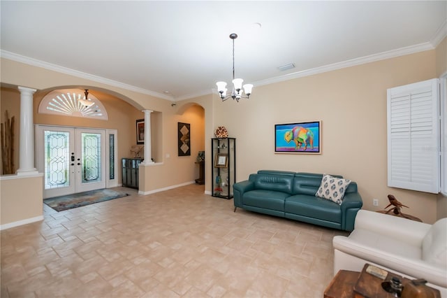 1062 Eagles Flight Way, North Port, FL 34287 - living room featuring decorative columns, arched walkways, a chandelier, stone finish flooring, and baseboards