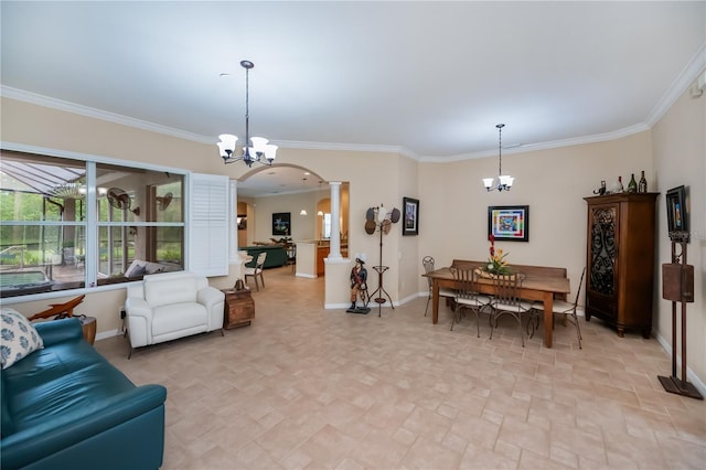 1062 Eagles Flight Way, North Port, FL 34287 - living room featuring a chandelier, ornate columns, arched walkways, ornamental molding, and baseboards