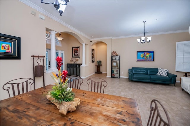 1062 Eagles Flight Way, North Port, FL 34287 - dining room with decorative columns, arched walkways, crown molding, baseboards, and a chandelier