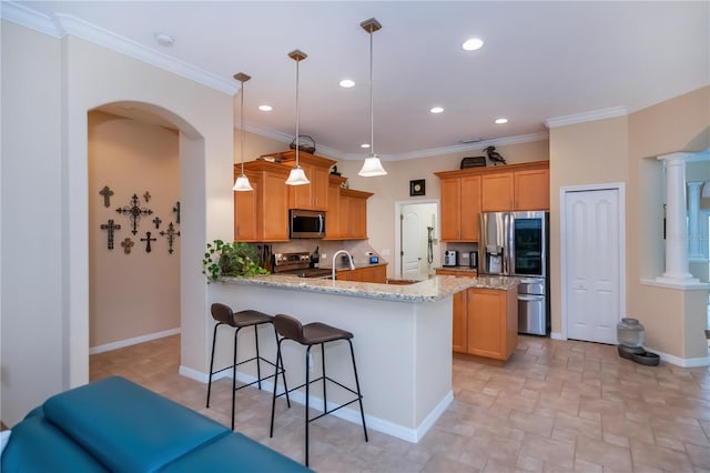 1062 Eagles Flight Way, North Port, FL 34287 - kitchen with appliances with stainless steel finishes, a peninsula, light stone counters, arched walkways, and recessed lighting