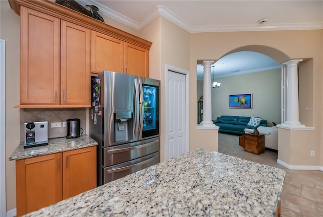 1062 Eagles Flight Way, North Port, FL 34287 - kitchen featuring stainless steel fridge with ice dispenser, decorative columns, arched walkways, decorative backsplash, and light stone counters