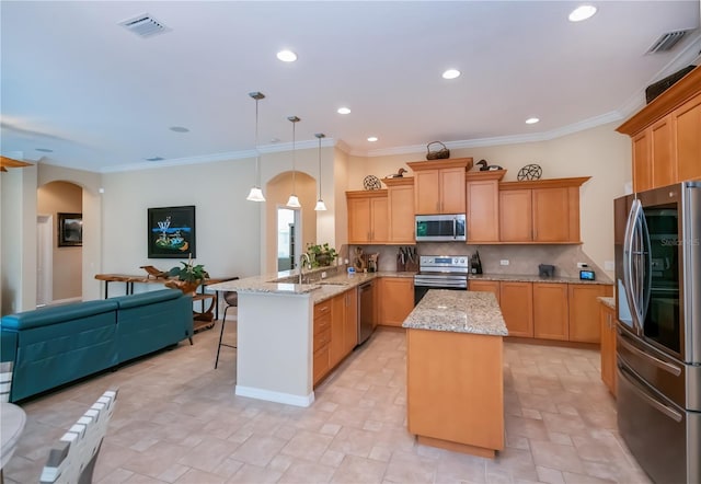 1062 Eagles Flight Way, North Port, FL 34287 - kitchen with stainless steel appliances, a peninsula, arched walkways, tasteful backsplash, and recessed lighting