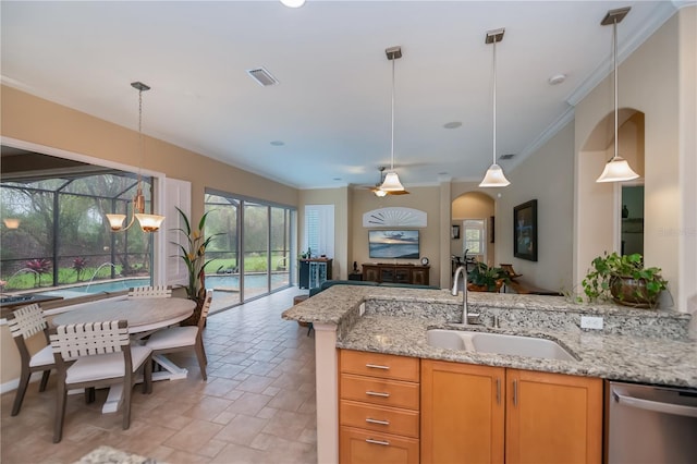 1062 Eagles Flight Way, North Port, FL 34287 - kitchen with stainless steel dishwasher, a sink, open floor plan, hanging light fixtures, and crown molding