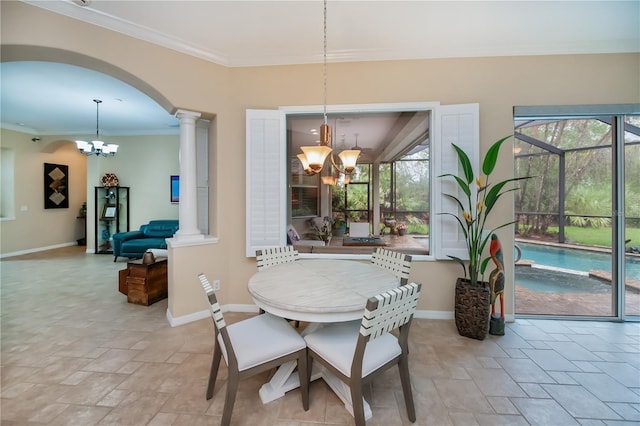 1062 Eagles Flight Way, North Port, FL 34287 - dining room featuring a chandelier, decorative columns, stone tile flooring, and crown molding