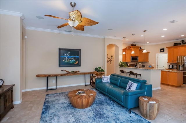 1062 Eagles Flight Way, North Port, FL 34287 - living room featuring arched walkways, a ceiling fan, recessed lighting, ornamental molding, and baseboards