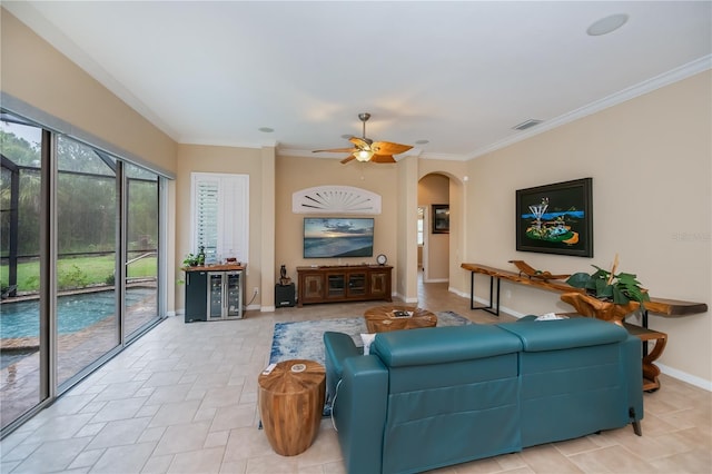 1062 Eagles Flight Way, North Port, FL 34287 - living area featuring arched walkways, ceiling fan, baseboards, and ornamental molding