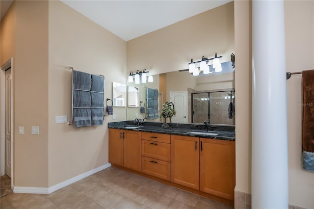 1062 Eagles Flight Way, North Port, FL 34287 - full bathroom featuring double vanity, a stall shower, tile patterned flooring, and baseboards