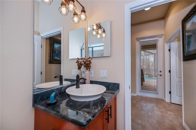 1062 Eagles Flight Way, North Port, FL 34287 - bathroom featuring vanity, a chandelier, and stone finish floors