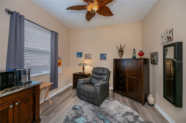 1062 Eagles Flight Way, North Port, FL 34287 - living area with a ceiling fan, light wood-style flooring, and baseboards