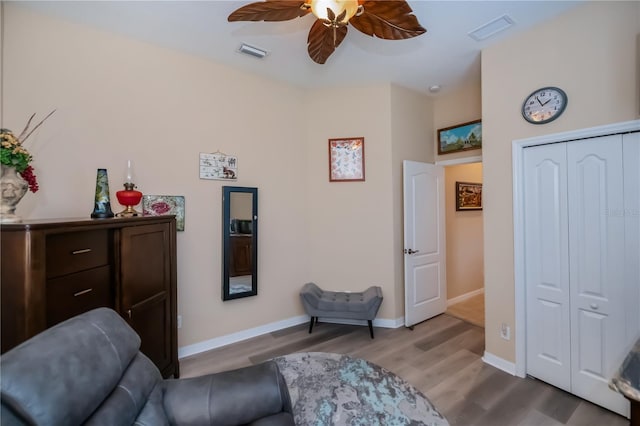 1062 Eagles Flight Way, North Port, FL 34287 - living area featuring wood finished floors, ceiling fan, and baseboards