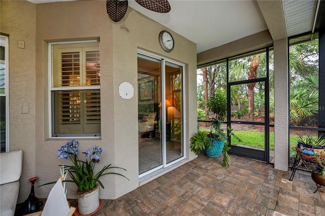 1062 Eagles Flight Way, North Port, FL 34287 - sunroom featuring a textured wall, plenty of natural light, and stone finish floors