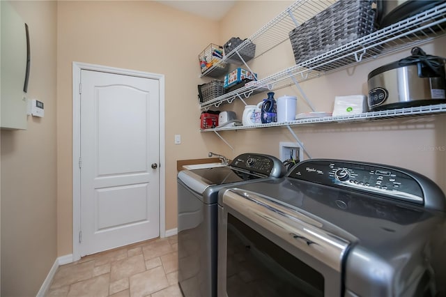 1062 Eagles Flight Way, North Port, FL 34287 - laundry area featuring baseboards, washer and clothes dryer, and light stone finish floors