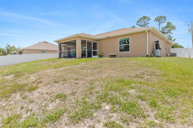 3138 Darius Ave, North Port, FL 34288 - back of property featuring a sunroom, stucco siding, and central AC unit