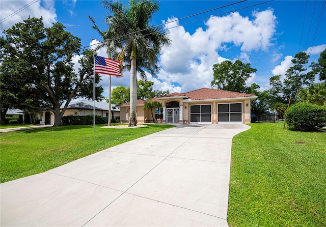 2387 Nuremberg Blvd, Punta Gorda, FL 33983 - mediterranean / spanish home with stucco siding, a front yard, a garage, concrete driveway, and a tile roof
