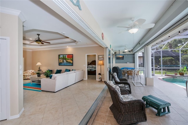 2387 Nuremberg Blvd, Punta Gorda, FL 33983 - living room featuring a ceiling fan, a sunroom, ornamental molding, a tray ceiling, and tile patterned flooring