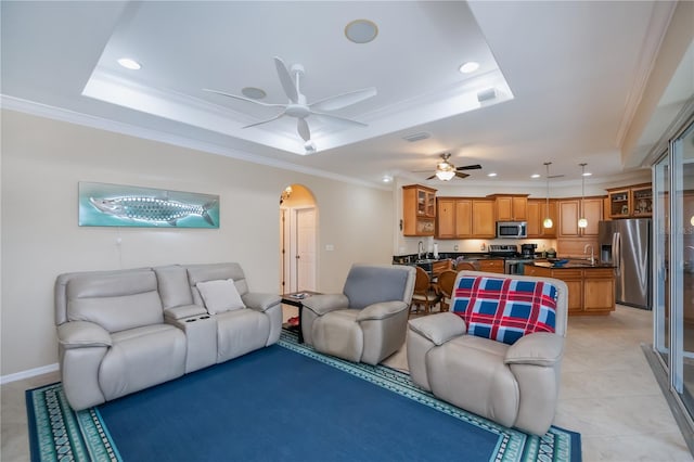 2387 Nuremberg Blvd, Punta Gorda, FL 33983 - living area with a tray ceiling, a ceiling fan, recessed lighting, arched walkways, and crown molding
