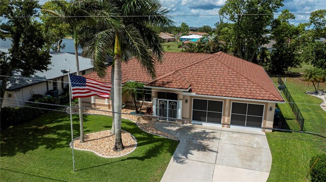 2387 Nuremberg Blvd, Punta Gorda, FL 33983 - view of front facade with a tile roof, stucco siding, and a front yard