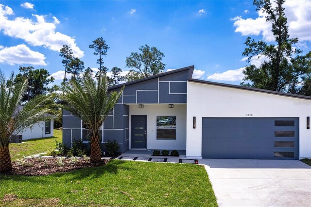 14174 Packard Ave, Port Charlotte, FL 33953 - contemporary house featuring stucco siding, an attached garage, concrete driveway, and a front yard