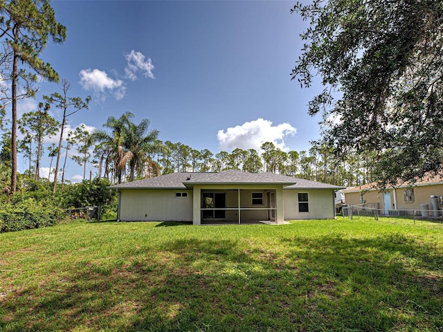 4609 Jaslo Ave, North Port, FL 34286 - rear view of house featuring stucco siding and a sunroom