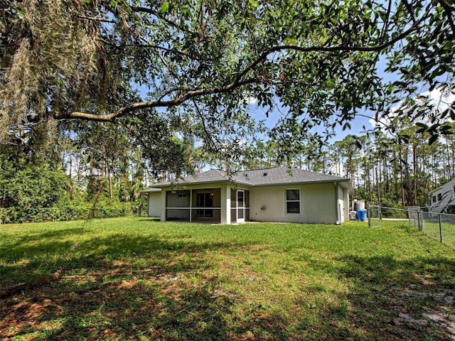 4609 Jaslo Ave, North Port, FL 34286 - rear view of house with stucco siding and a sunroom