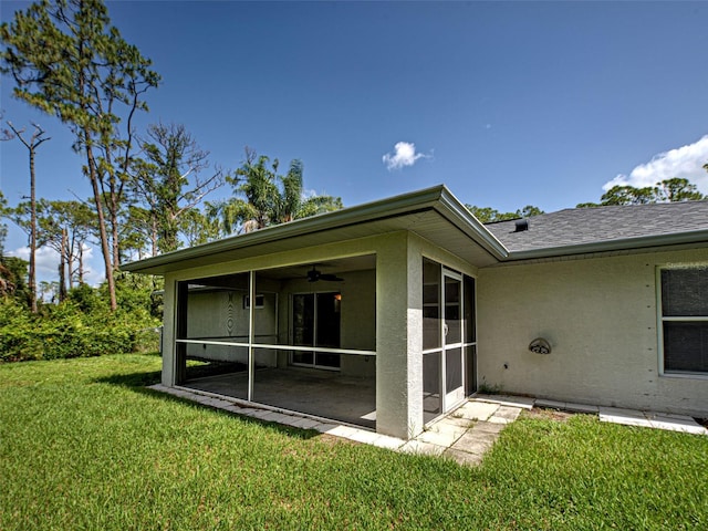 4609 Jaslo Ave, North Port, FL 34286 - back of house featuring a sunroom, stucco siding, a lawn, and ceiling fan