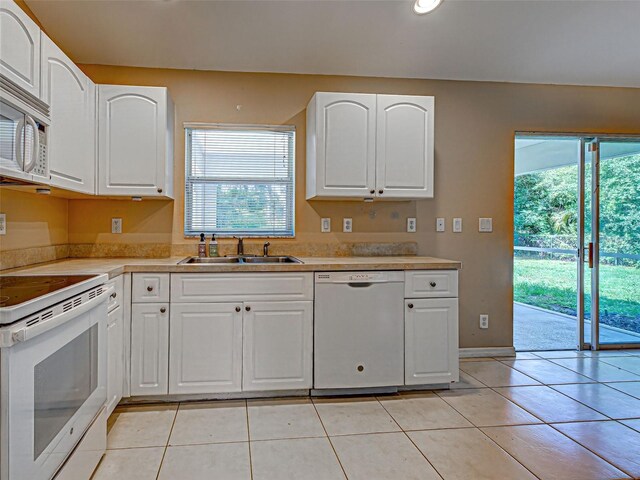 4609 Jaslo Ave, North Port, FL 34286 - kitchen with white appliances, a sink, light tile patterned floors, and healthy amount of natural light