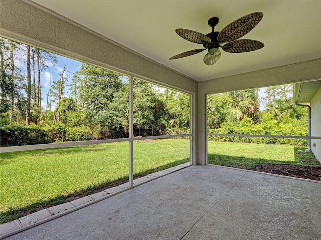 4609 Jaslo Ave, North Port, FL 34286 - unfurnished sunroom featuring a ceiling fan and view of wooded area