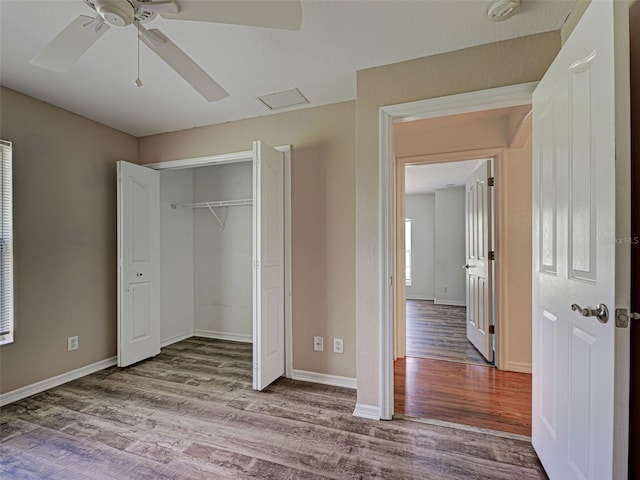 4609 Jaslo Ave, North Port, FL 34286 - unfurnished bedroom featuring wood finished floors, a closet, baseboards, and a ceiling fan