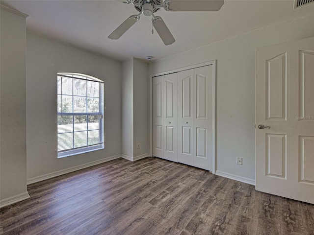 4609 Jaslo Ave, North Port, FL 34286 - unfurnished bedroom with wood finished floors, a closet, baseboards, and a ceiling fan