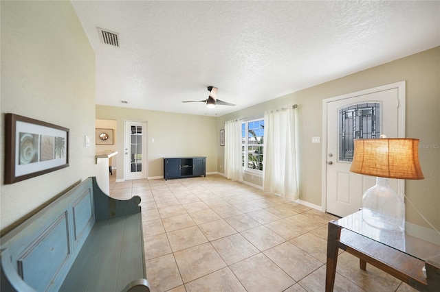 3171 Highlands Rd, Punta Gorda, FL 33983 - living room with a textured ceiling, light tile patterned floors, and ceiling fan