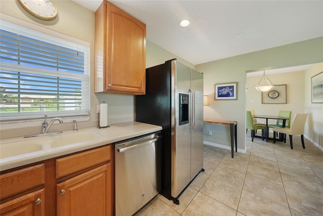 3171 Highlands Rd, Punta Gorda, FL 33983 - kitchen with stainless steel appliances, light countertops, light tile patterned flooring, recessed lighting, and brown cabinetry