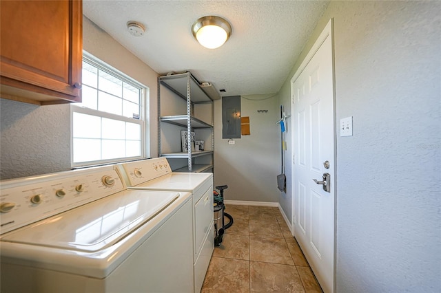 3171 Highlands Rd, Punta Gorda, FL 33983 - washroom featuring cabinet space, washing machine and dryer, a textured ceiling, electric panel, and light tile patterned flooring
