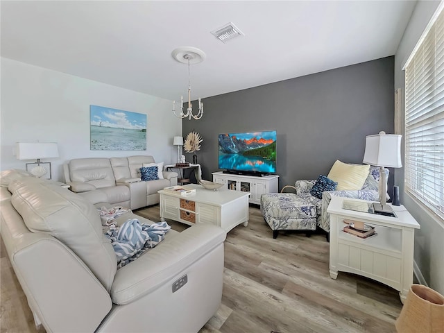 7292 Mikasa Dr, Punta Gorda, FL 33950 - living area with light wood-type flooring and a chandelier