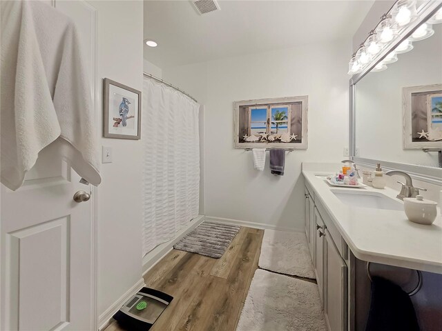 7292 Mikasa Dr, Punta Gorda, FL 33950 - bathroom with vanity, wood finished floors, and baseboards