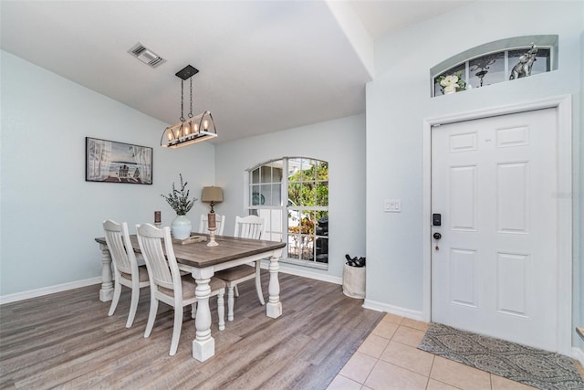 1444 Frisco Ter, Port Charlotte, FL 33953 - dining room featuring baseboards, a chandelier, and light wood finished floors