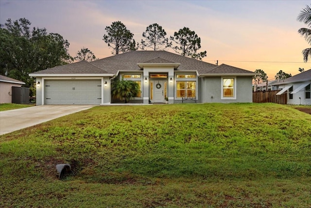 5436 Jessamine Ave, North Port, FL 34291 - view of front facade with concrete driveway, an attached garage, stucco siding, and roof with shingles