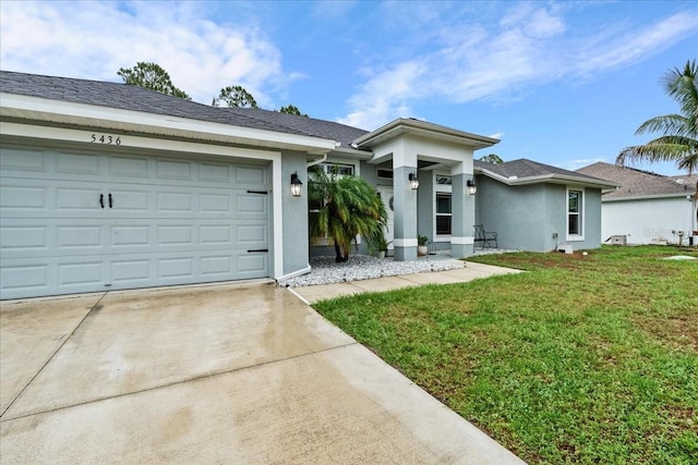5436 Jessamine Ave, North Port, FL 34291 - view of front of home featuring stucco siding, concrete driveway, a front yard, and a garage