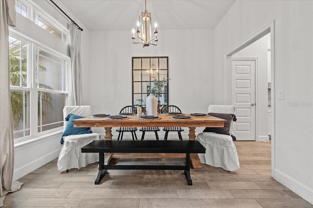 5436 Jessamine Ave, North Port, FL 34291 - dining area featuring a chandelier, wood tiled floors, and baseboards