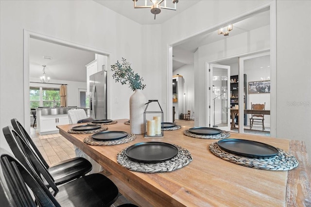 5436 Jessamine Ave, North Port, FL 34291 - dining area featuring a chandelier and wood finished floors