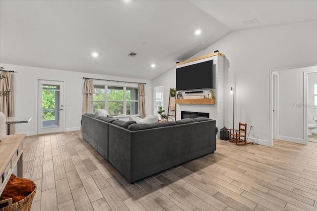 5436 Jessamine Ave, North Port, FL 34291 - living area featuring a glass covered fireplace, light wood-style floors, baseboards, recessed lighting, and high vaulted ceiling