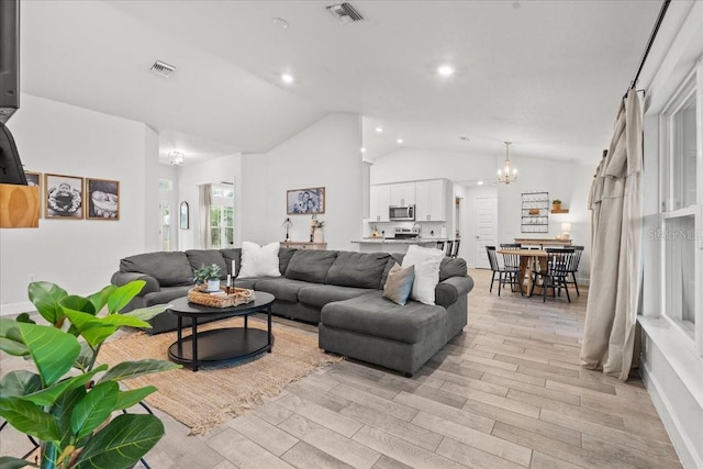 5436 Jessamine Ave, North Port, FL 34291 - living room featuring vaulted ceiling, a chandelier, light wood finished floors, and recessed lighting