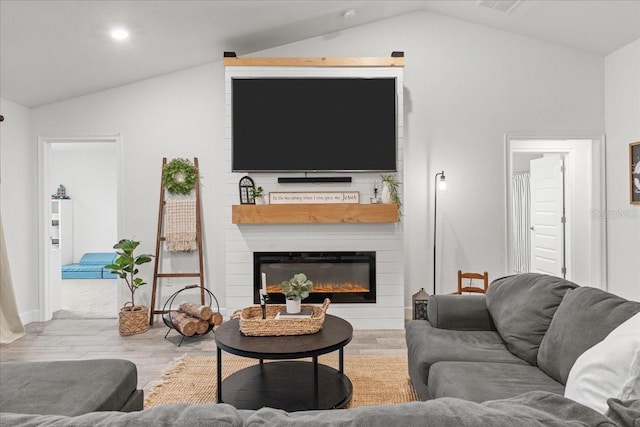 5436 Jessamine Ave, North Port, FL 34291 - living room featuring lofted ceiling, wood finished floors, a fireplace, and recessed lighting