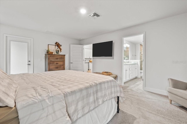 5436 Jessamine Ave, North Port, FL 34291 - bedroom with light colored carpet, baseboards, and ensuite bath