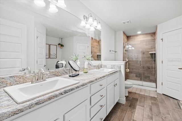 5436 Jessamine Ave, North Port, FL 34291 - full bath featuring double vanity, a shower stall, toilet, wood finished floors, and recessed lighting