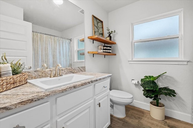 5436 Jessamine Ave, North Port, FL 34291 - full bathroom with vanity, toilet, wood finished floors, baseboards, and a shower with shower curtain